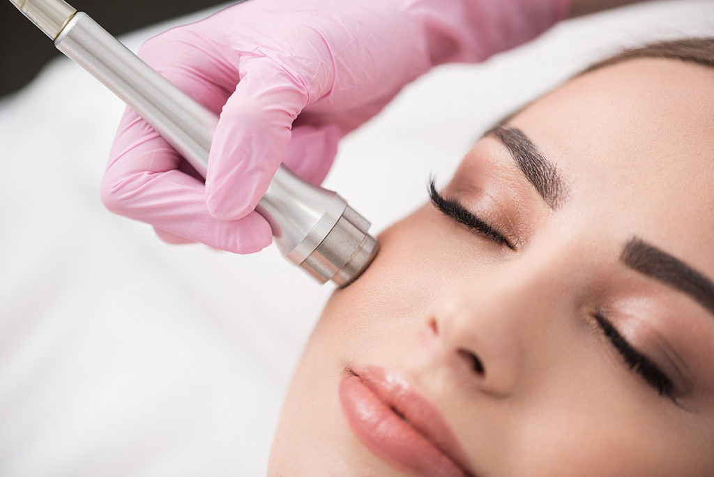 woman getting microdermabrasion treatment